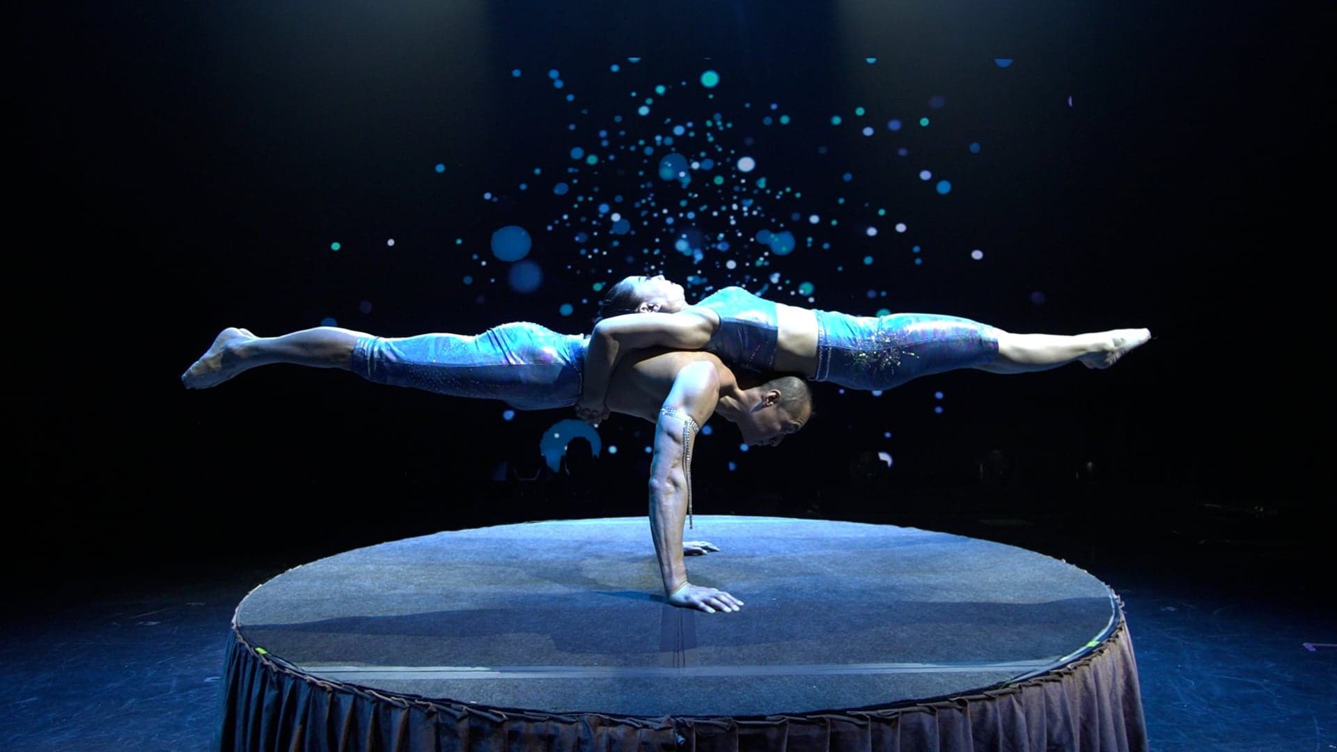 Two Amazing Acrobats of Shanghai performers balancing in a one-hand stand on stage in Branson