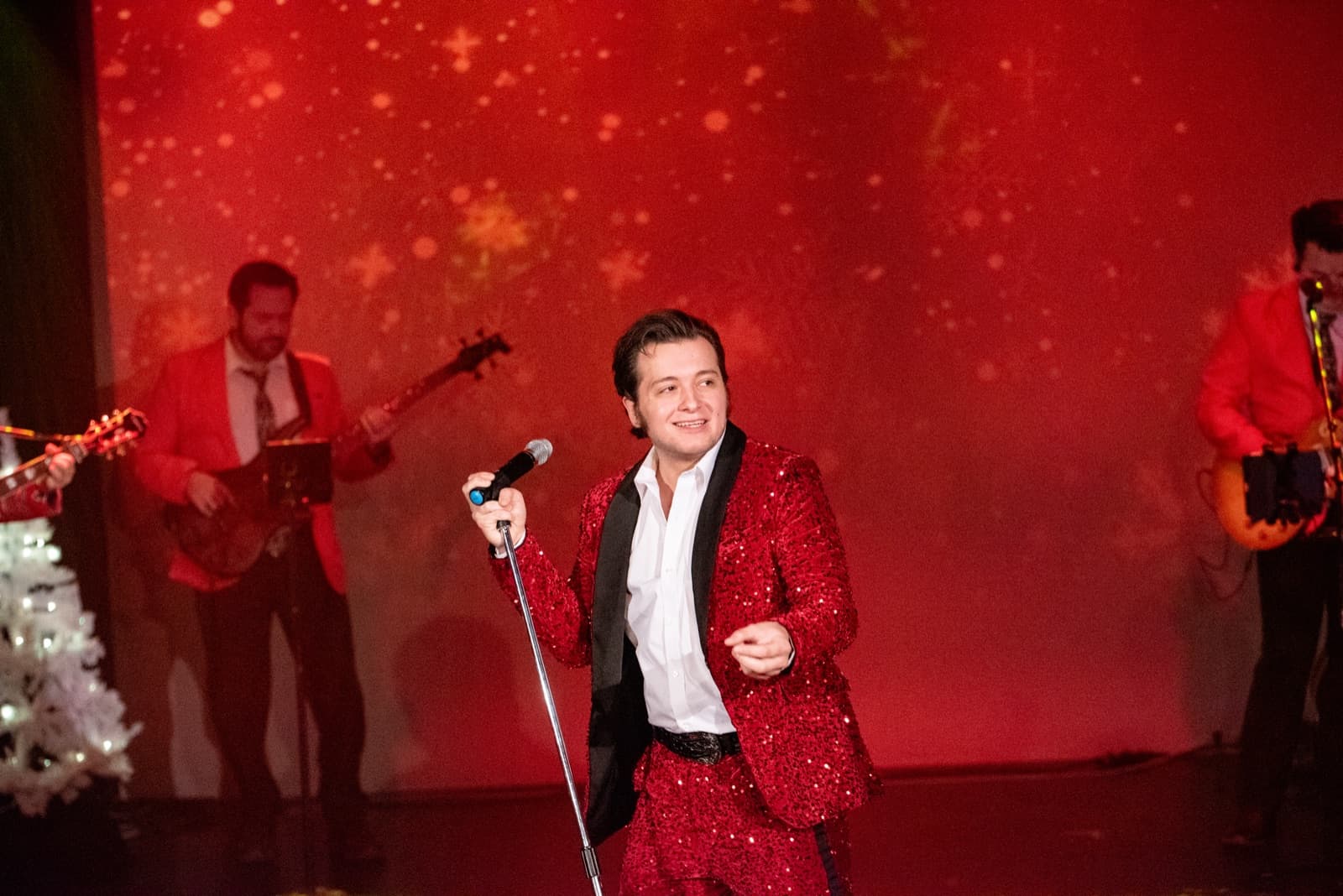 Matthew Boyce performing in a red suit at the Retro Christmas show in Branson