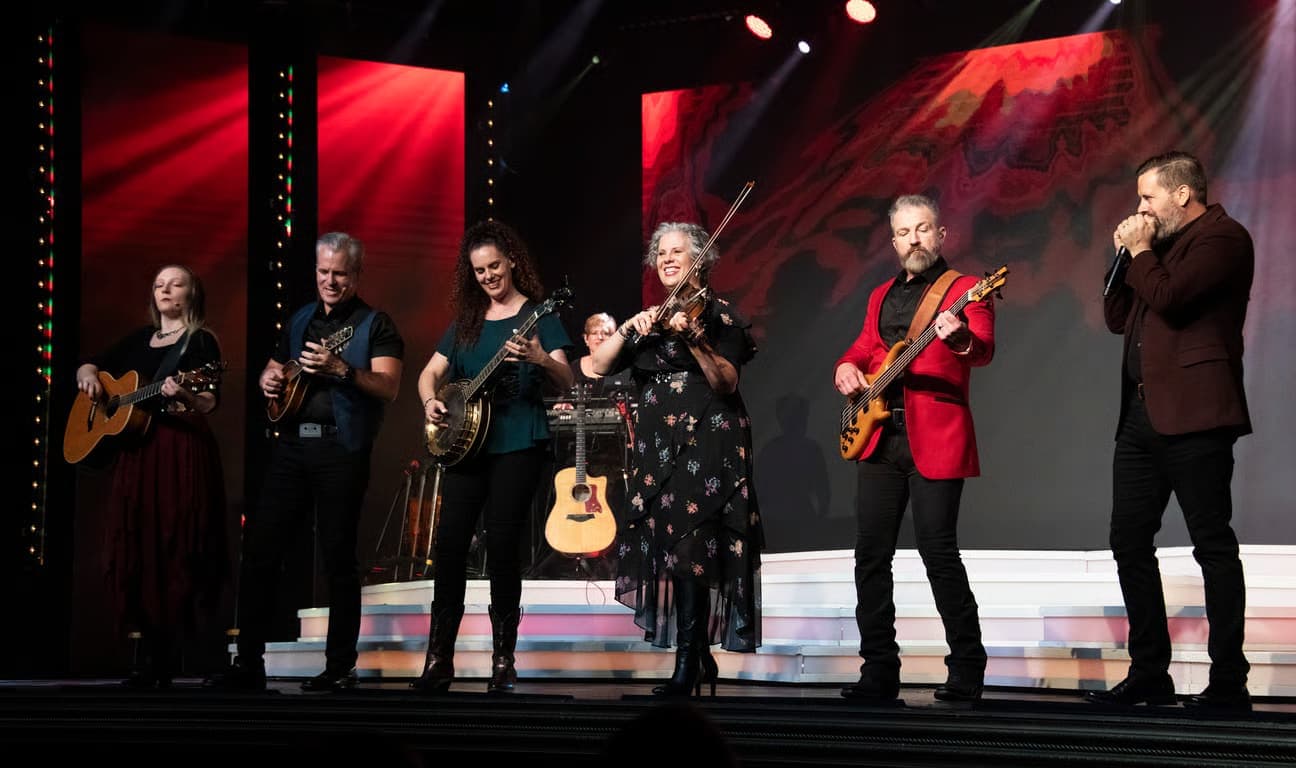 The Duttons family performing on stage with multiple instruments at the Dutton Family Theater in Branson